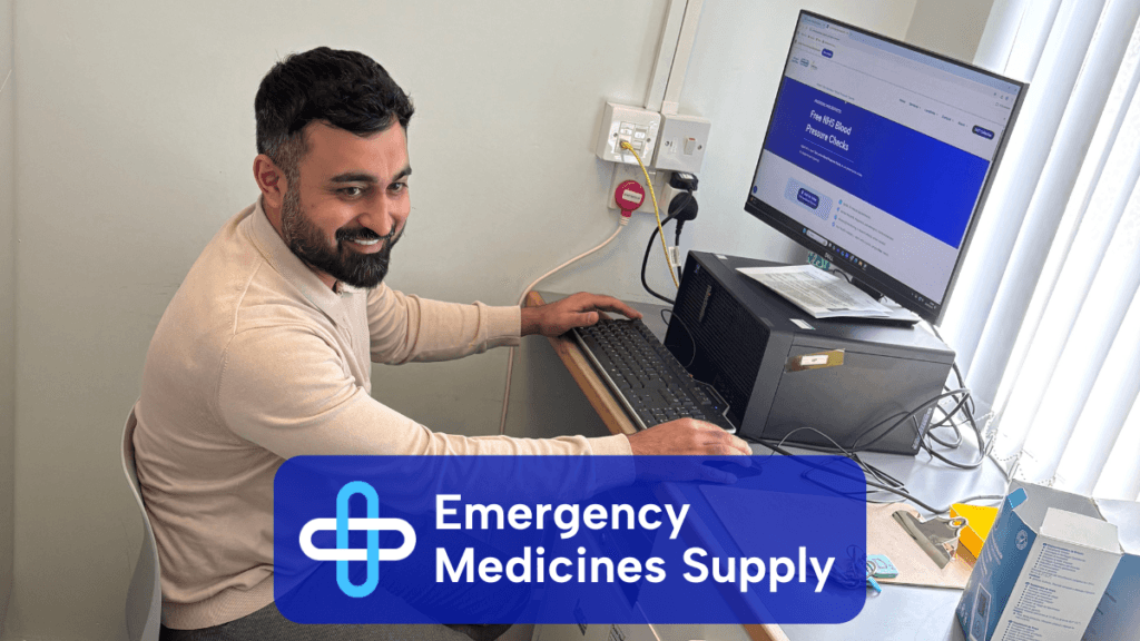 A pharmacist performing a consultation whilst using a computer in the consulting room. A text overlay reads 'Emergency Medicines Supply' with the Wellway and Central Pharmacies cross logo.