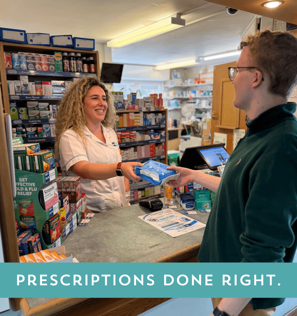 Friendly Pharmacy Supervisor Rafaela is handing out a prescription to a customer at the pharmacy counter whilst smiling. Text captions reads 'Prescriptions Done Right'.