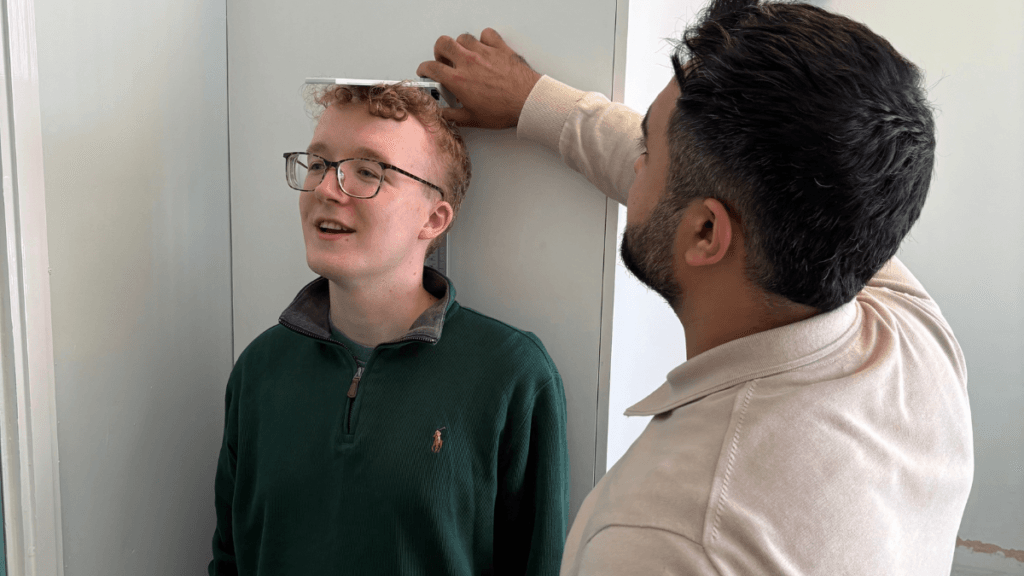 Height-Measurement Check Our pharmacist checking the height of a patient in our comfortable consulting room.
