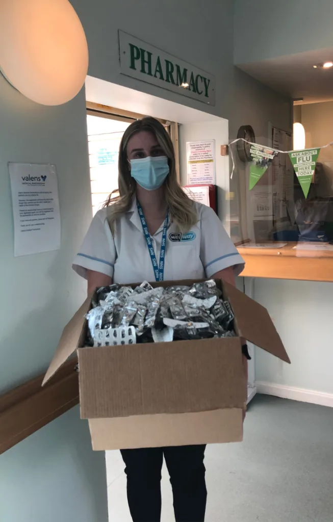Medicines Recycling Jessica holding a box of blister packets for recycling during our old medicines pack recycling scheme.